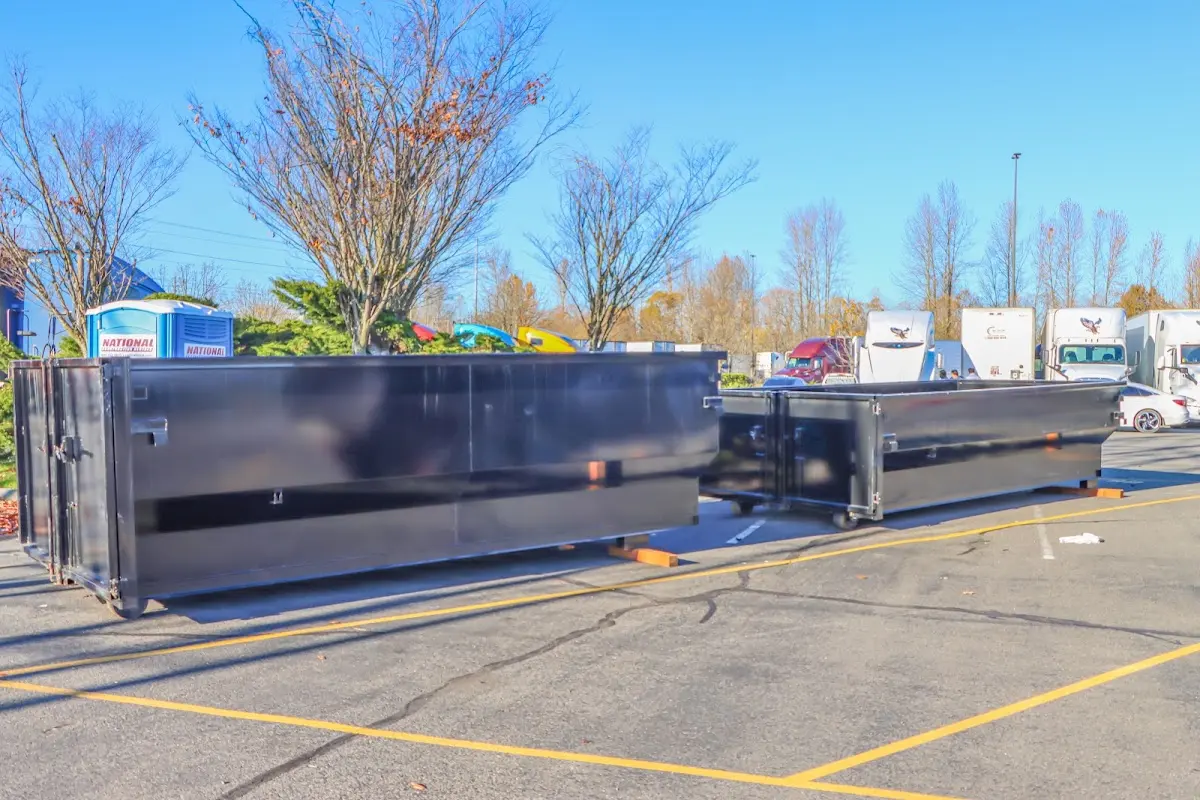 Professional dumpster rental service with roll-off container on residential driveway in Crawfordsville